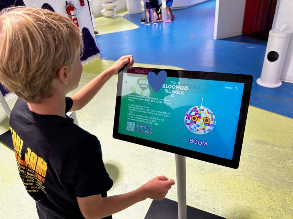 Boy chooses his Sloomoo sidekick on a computer screen inside a room at the Sloomoo Institute in Chicago, Illinois.
