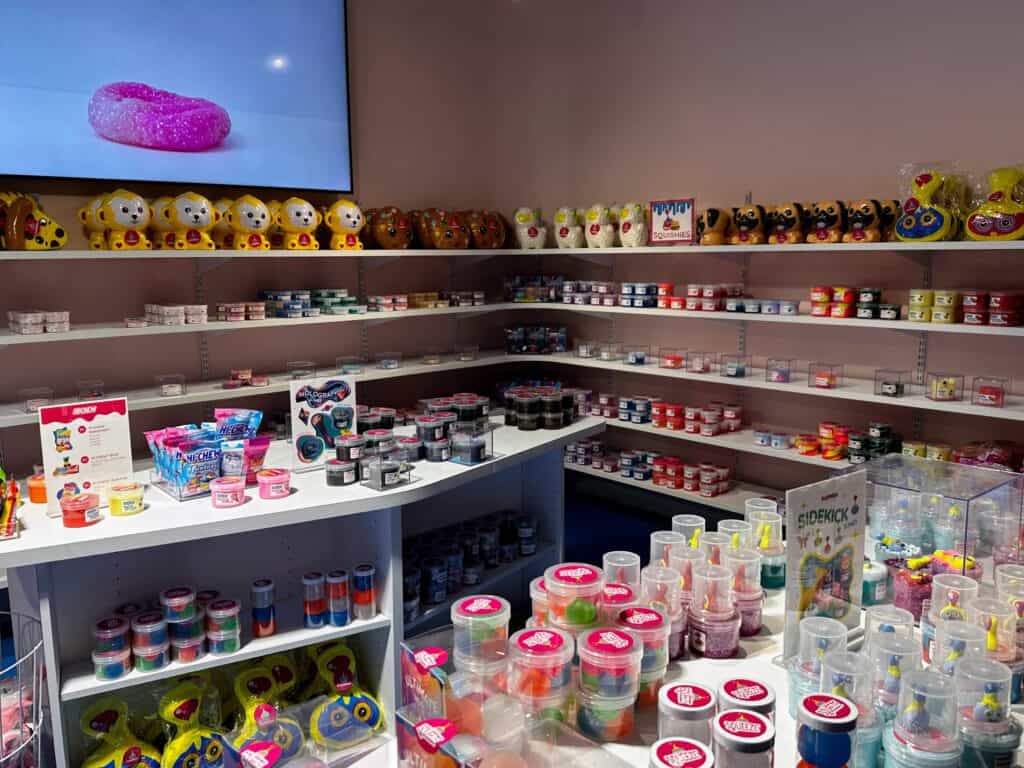Colorful shelves of slime and toys on display at the gift shop at the Sloomoo Institute in Chicago, Illinois.