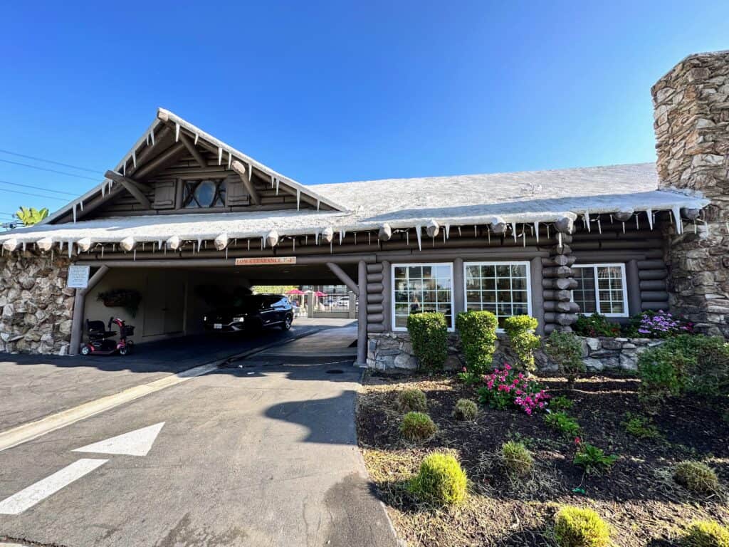 Front entrance of a hotel in Anaheim California (it's the Alpine Inn). Fake icicles hang from the roof.
