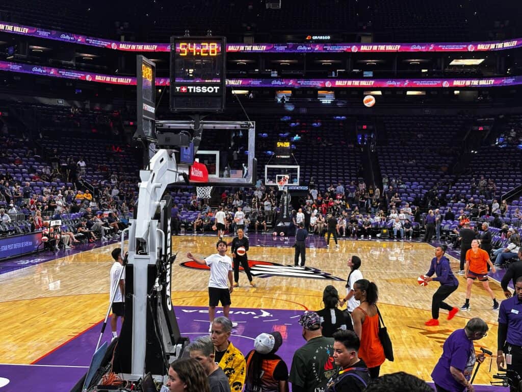 Phoenix Mercury players warm up pre-game in their arena before they face the Indiana Fever. The clock shows 54:28 until tipoff.