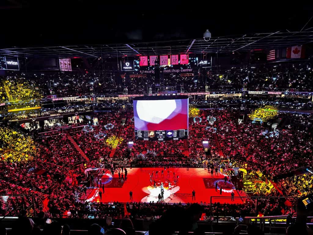 Colorful lights light up the arena in Phoenix at a Suns vs Lakers NBA game.